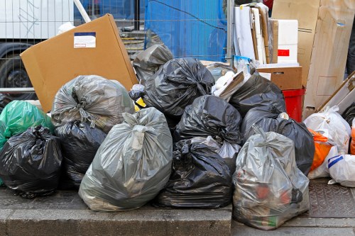 Professional rubbish removal vehicle working in a busy London street